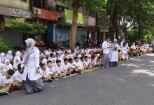 Siswa SD Muhammadiyah 1 Solo memberi penghormatan terakhir PB XIII di Jalan Slamet Riyadi