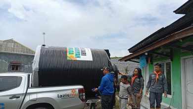 Relawan Lazismu dan MDMC Muhammadiyah Purbalingga menurunkan tangki air bantuan untuk warga Dusun Gunung Malang, Desa Serang, Karangreja, pasca banjir.