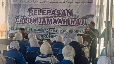 Suasana pelepasan calon jamaah haji KBIHU Arofah Muhammadiyah Brebes di Gedung PDM Brebes, dengan peserta berseragam biru mengikuti sambutan di depan banner acara.