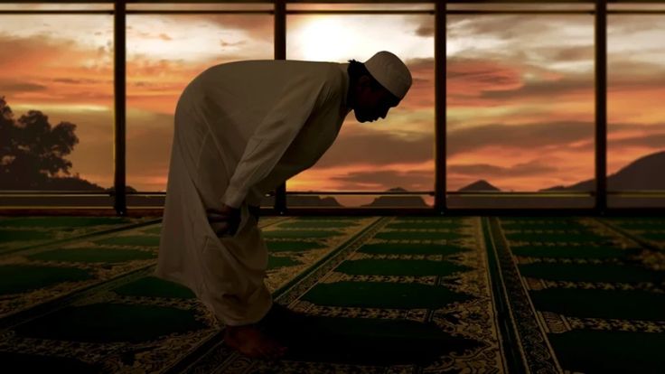 Ilustrasi seorang muslim sedang rukuk dalam salat di dalam masjid dengan latar cahaya senja.