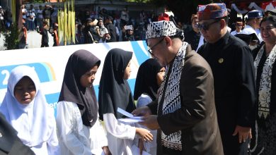 Mendikdasmen Abdul Mu’ti memberikan santunan kepada siswi sekolah dasar saat peringatan Hardiknas 2026 di Banyuwangi.