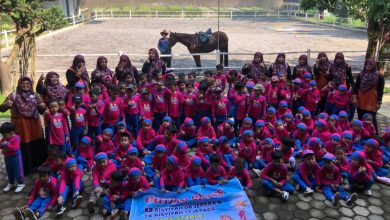Foto bersama ratusan siswa TK Aisyiyah di Hufadz Stable dengan latar belakang kuda dan pelatih.