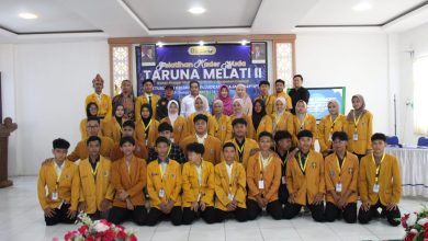 Foto bersama peserta dan panitia Pelatihan Kader Muda Taruna Melati II IPM Cilacap mengenakan jas almamater kuning di aula kegiatan.