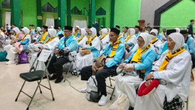 Suasana jamaah haji Cilacap dari KBIHU Al Mabrur saat mengikuti prosesi pelepasan keberangkatan haji 2026 di dalam gedung dengan seragam bernuansa biru dan putih.