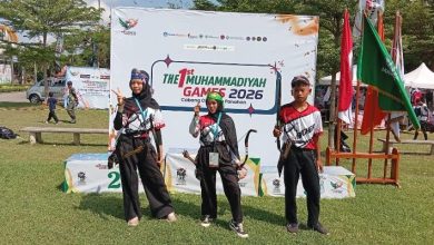 Tiga atlet panahan remaja berpose di depan backdrop The 1st Muhammadiyah Games 2026 Cabang Olahraga Panahan.