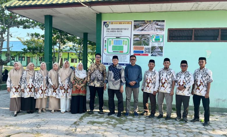 Para guru dan jajaran pimpinan SMA Muhammadiyah 2 Palangkaraya berfoto bersama tim penjaminan mutu PP Muhammadiyah di depan maket sport center sekolah.