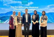 Empat dosen wanita Fakultas Farmasi UMP berfoto bersama seorang pembicara internasional di depan layar besar bertuliskan MMCS 2026 di Beijing China.