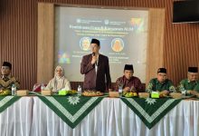 Suasana Pembinaan Guru & Karyawan Amal Usaha Muhammadiyah (AUM) Kebakkramat di MTC Sapen. Di atas panggung, terlihat Ketua PDM Karanganyar, Muhammad Arief Babhier, memberikan sambutan. Di belakangnya terdapat layar proyeksi besar.