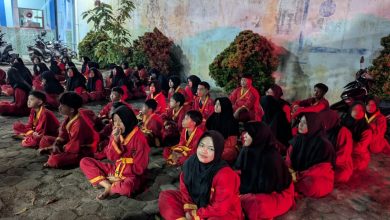 Puluhan kader muda Tapak Suci Blora mengenakan seragam merah khas pesilat Muhammadiyah duduk bersila di halaman saat mengikuti materi ruangan malam hari pada Ujian Kenaikan Tingkat (UKT) di Kunduran.