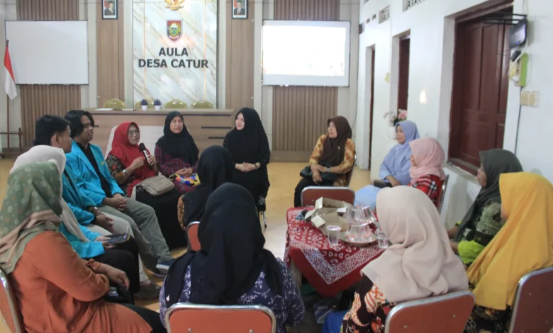 Sekelompok mahasiswa berjas almamater biru muda dan warga Desa Catur, Boyolali, mengikuti sesi diskusi kelompok melingkar dalam kegiatan pelatihan Pojok Harmoni tentang solusi kesehatan mental ibu di Aula Desa Catur.