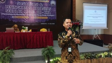 Seorang pria berbaju batik memberikan presentasi mengenai Kebijakan Implementasi Sekolah Model PM dan KKA di SD Muhammadiyah 1 Solo.