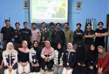 Tim Mahasiswa KKN MAs Kelompok 39 Malang bersama pemuda Karang Taruna Dusun Codo, Wagir, berfoto bersama setelah sesi presentasi pembuatan pestisida nabati daun cengkeh di dalam ruangan, dengan latar belakang layar proyeksi yang menyala.