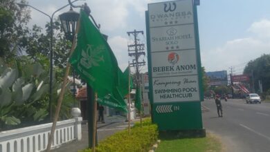 Deretan bendera hijau Muktamar Nasyiatul Aisyiyah terpasang di trotoar pinggir jalan raya depan area Syariah Hotel Solo.