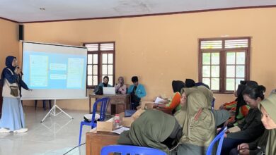 Mahasiswi Tim PPK Ormawa UMS memaparkan strategi pemasaran digital menggunakan slide presentasi di hadapan kelompok Ibupreneur pelaku UMKM Desa Musuk, Boyolali.