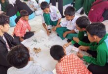Santri Pondok Pesantren Darul Arqom Purworejo dan mahasiswa UTP Malaysia berdiskusi mengerjakan modul modul STEM di atas kertas karton.