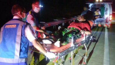 Petugas medis dan Jasa Marga mengevakuasi korban kecelakaan Tol Batang-Weleri dari anggota KOKAM Semarang menggunakan tandu ke dalam ambulans pada malam hari.