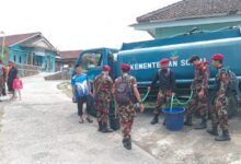 Personel KOKAM dan BikersMu menyalurkan bantuan air bersih Temanggung dari truk tangki ke ember warga di Kaloran.